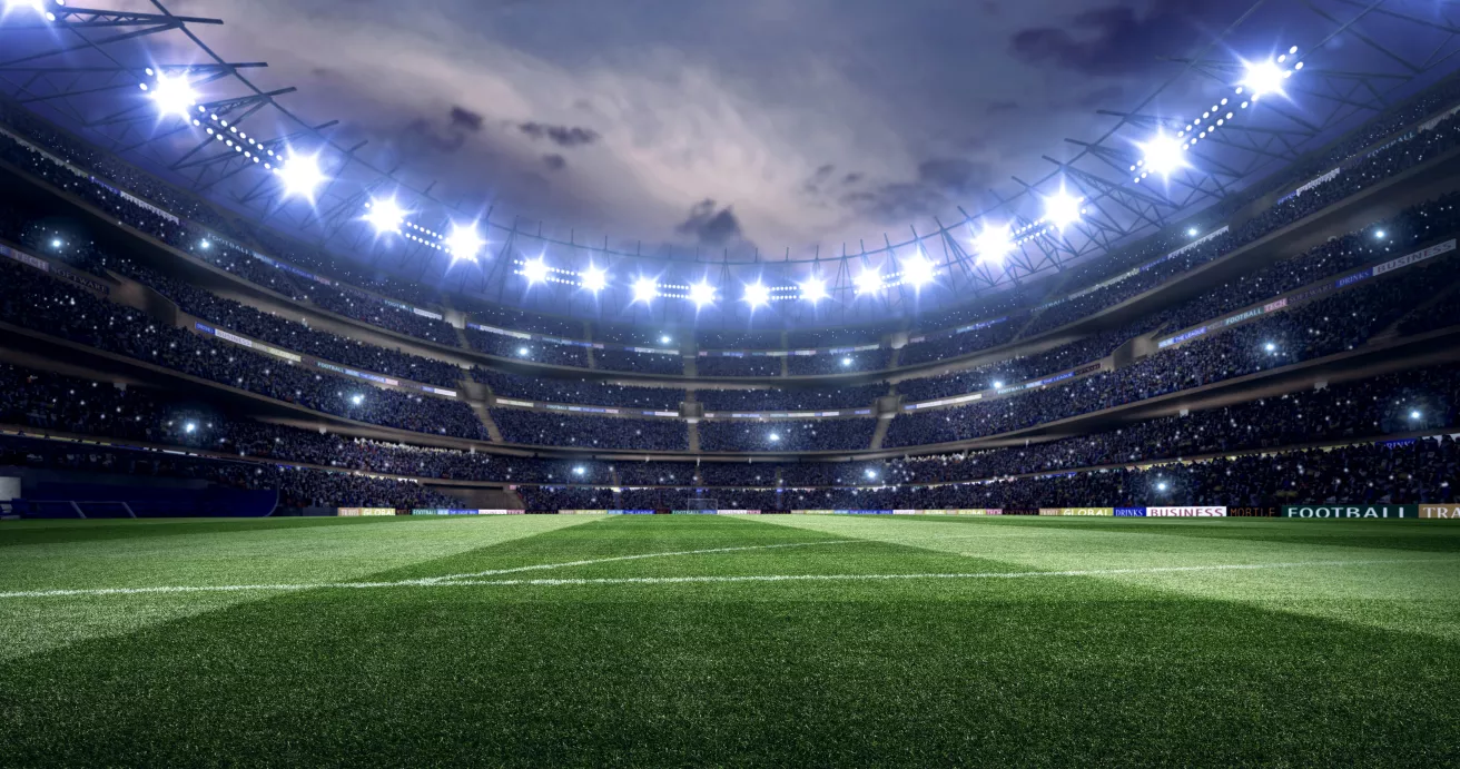 Dramatic soccer stadium with bleachers full of people.