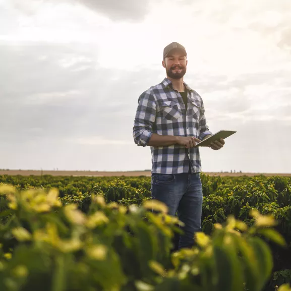 Photo of a man in a coffee plantaction, a researcher.