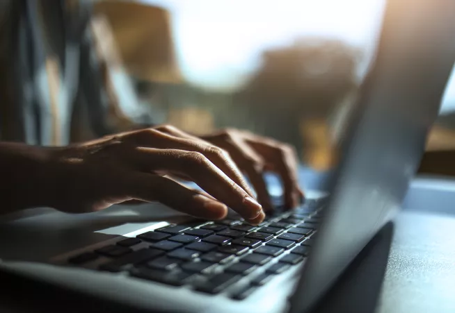 Close up of a hands on a keyboard.