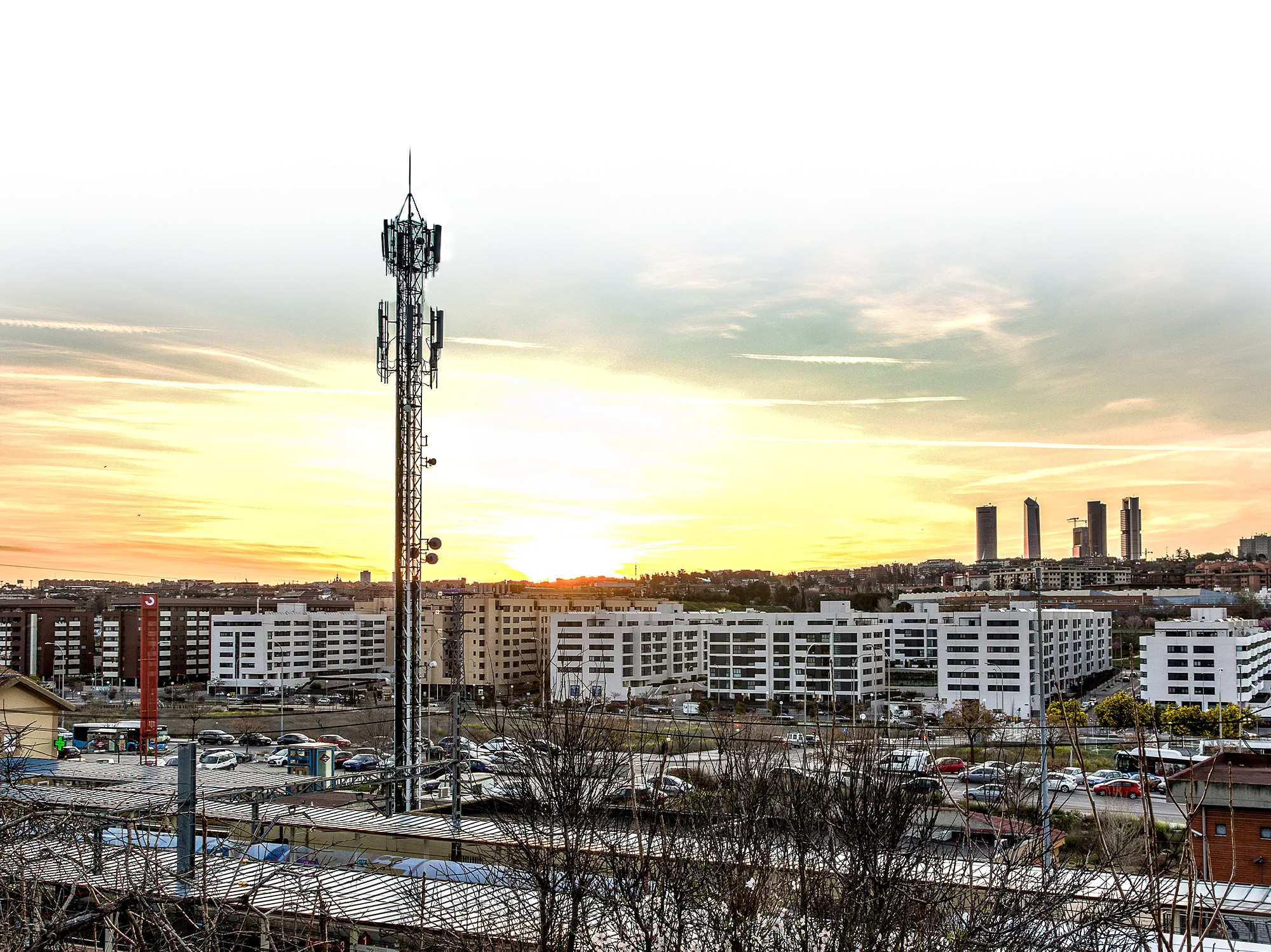 Cell tower in a city landscape at dusk